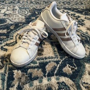 White size 8 adidas sneakers with rose gold details.